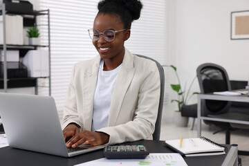 Professional accountant working on computer at desk in office