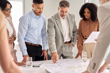 Diverse multiethnic executive business team people group working with paperwork standing at table, analyzing corporate strategy, reviewing plan, managing financial project overview at office meeting.