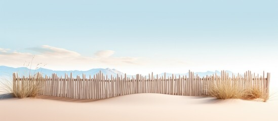 Picturesque fence on sandy beach dunes amidst hills
