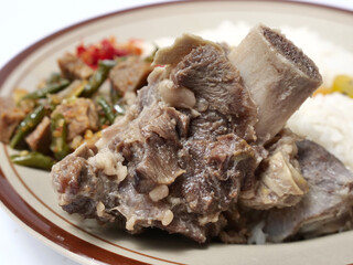 Nasi campur iga and tempe, mixed rice served with beef ribs, tempeh and chili sauce