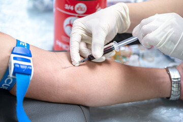 Close up hand of nurse, taking blood sample from a patient in the hospital.	