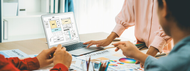 Cropped image of interior designer team discuss the material color while laptop displayed website...