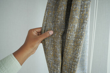  men hand checking clean fabric curtain.