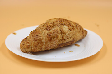 Croissant on white plate on an isolated background