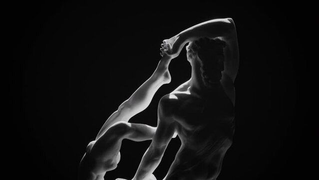 Front-upper side of the marble sculpture of Hercules and Lichas rotating on a black background