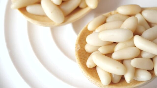Healthy pine nuts isolated on white background.