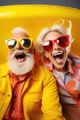 Retired husband and wife, wearing glasses on a bright background, shouting with joy