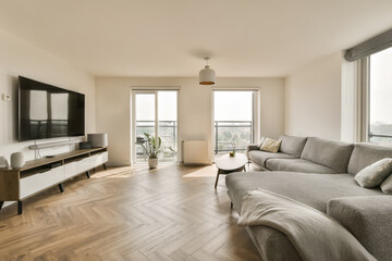 a living room with wood flooring and large windows looking out onto the cityscapea is on the wall
