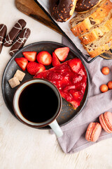 Cup of coffee with waffle, cookies, cake and dunut on light background. Hot drink and desserts