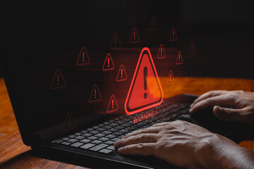 IT staff, programmers, developers use computer with warning triangle sign for error notification...