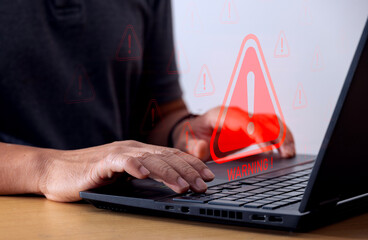 IT staff, programmers, developers use computer with warning triangle sign for error notification...