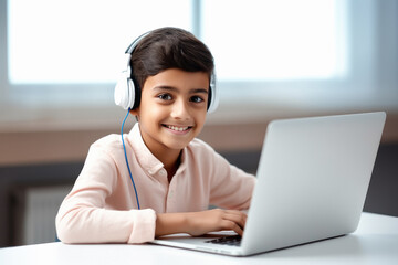 Cute little boy student using laptop, smiling - Powered by Adobe