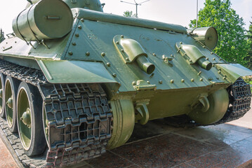 Fototapeta na wymiar Suspension and tracks of the tank. Exhaust pipes at the back. Military technics. Tank on a pedestal. 