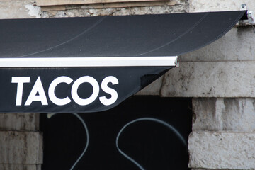 tacos text fastfood restaurant signboard on facade entrance sign