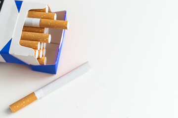 Pack full of filtered cigarettes on white isolated background.