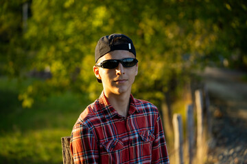 Teenage boy in green nature waiting for magic. Inquisitive childhood.