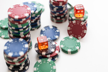 Stack of poker chips. Colorful tokens. Card game and gambling. Casino and gaming. Close-up on white table.