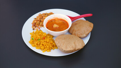 Indian food deep fried Puri Bhaji or Aloo ki Sabji, Potatoes and kheer.