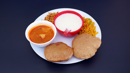 Indian food deep fried Puri Bhaji or Aloo ki Sabji, Potatoes and kheer.