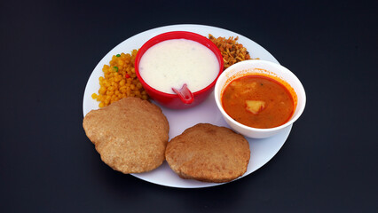 Indian food deep fried Puri Bhaji or Aloo ki Sabji, Potatoes and kheer.