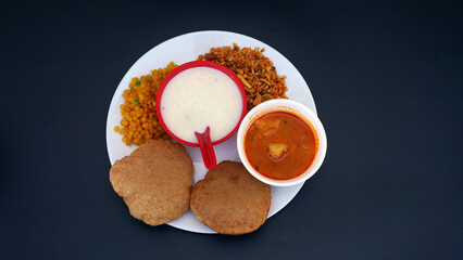 Indian food deep fried Puri Bhaji or Aloo ki Sabji, Potatoes and kheer.