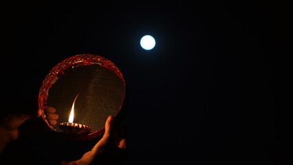 Karwa Chauth strainer and Diya oil lamps for the Karwa Chauth celebration on the night