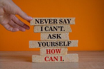 Motivational and Inspirational quotes -Never say i can't. Ask yourself how can i. Words on brick...