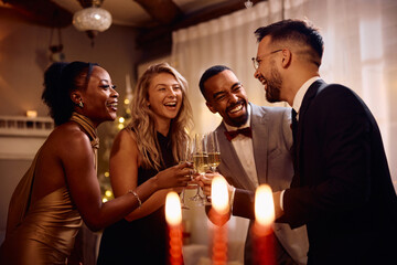 Cheerful friends have fun while toasting during New Year's party.