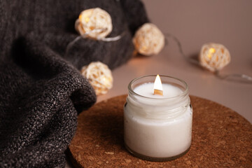 Fototapeta na wymiar Candle in home interior with warm lights, calming glow, Spa Relaxation, Aromatic decor