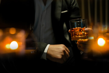 Closeup businessmen holding a glass of whiskey