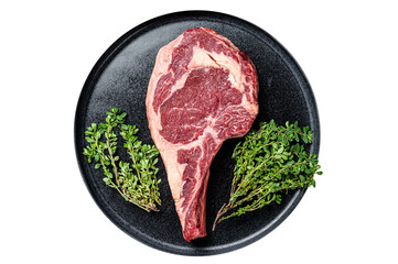 Dry aged cowboy or rib eye steak, raw beef meat with herbs. Black background. Top view