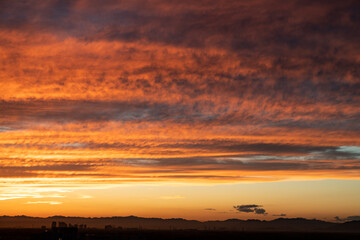 Sunset, clouds on the horizon illuminated by the red light of the sun