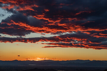 Sunset, clouds on the horizon illuminated by the red light of the sun