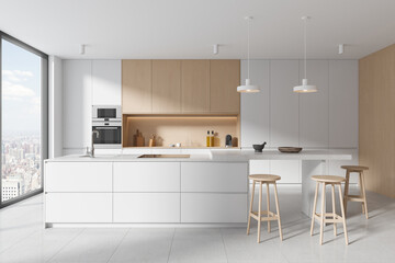 Stylish home kitchen interior with bar island and cooking space, window
