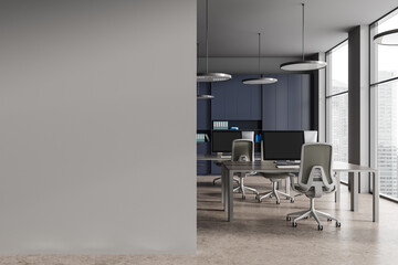 Blue and gray open space office with blank wall