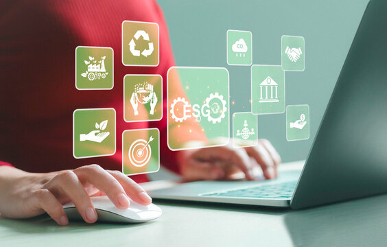 Business concept, social investment, environment, ESG. Woman uses computer to analyze ESG surrounded by icons. On the computer screen in business investment strategy concept