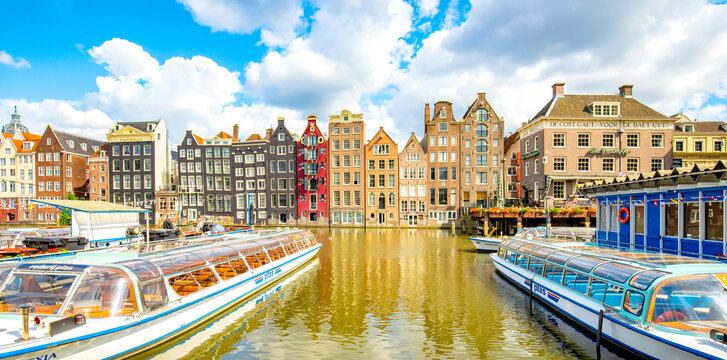 Panoramic view of Amsterdam city, famous dancing houses over Damrak canal, Netherlands 2023