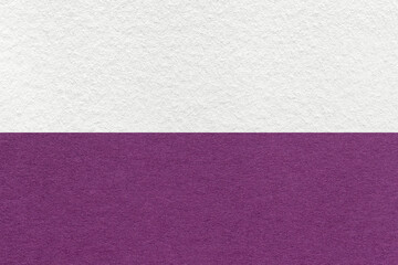 Texture of craft white and violet paper background, half two colors, macro. Vintage purple cardboard