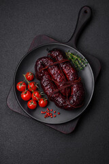 Delicious black blood sausage or black pudding with spices and herbs