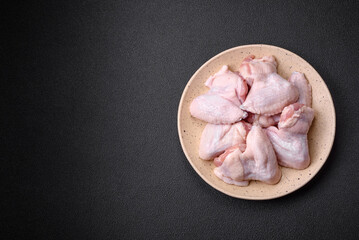 Fresh raw chicken wings with salt and spices prepared for baking