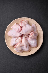 Fresh raw chicken wings with salt and spices prepared for baking