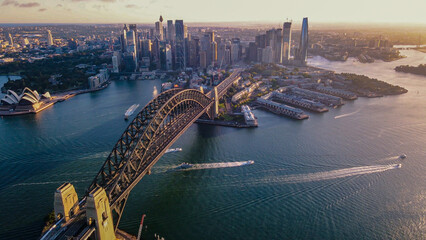 Aerial drone view of Sydney City and Sydney Harbour showing Sydney Harbour Bridge in the late afternoon     