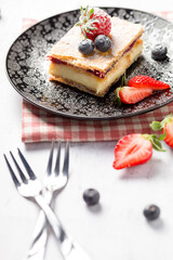 A piece of Napoleon cake with poppy seeds and cherries