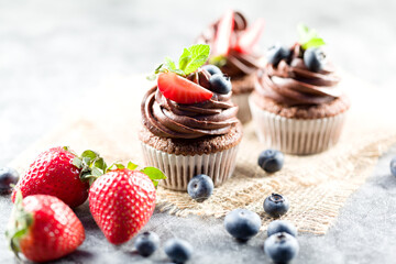 Chocolate cupcakes. Freshly baked muffins with fresh berries
