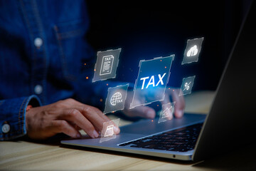 income tax concept. Businessman using laptop analyzing data to online income tax form. tax system icon around. pay online income tax. futuristic virtual screen interface technology..