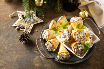 Creative appetizers christmas. Lavash roll cone with chicken and mushroom salad on a plate. Copy space.