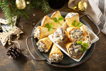 Creative appetizers christmas. Lavash roll cone with chicken and mushroom salad on a plate.