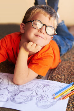 Portrait, outdoor and boy with a sketch, drawing and artistic with creativity, thinking and development. Person, student and face with paper, pencil and smile with project, learning and knowledge