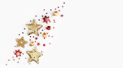 Beautiful creative minimalistic Christmas composition with golden red stars and balls on a white background. Flat lay, top view.