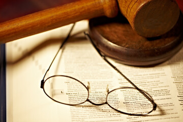 Table, law and a report, glasses and gavel for a court decision, notes or a justice report....